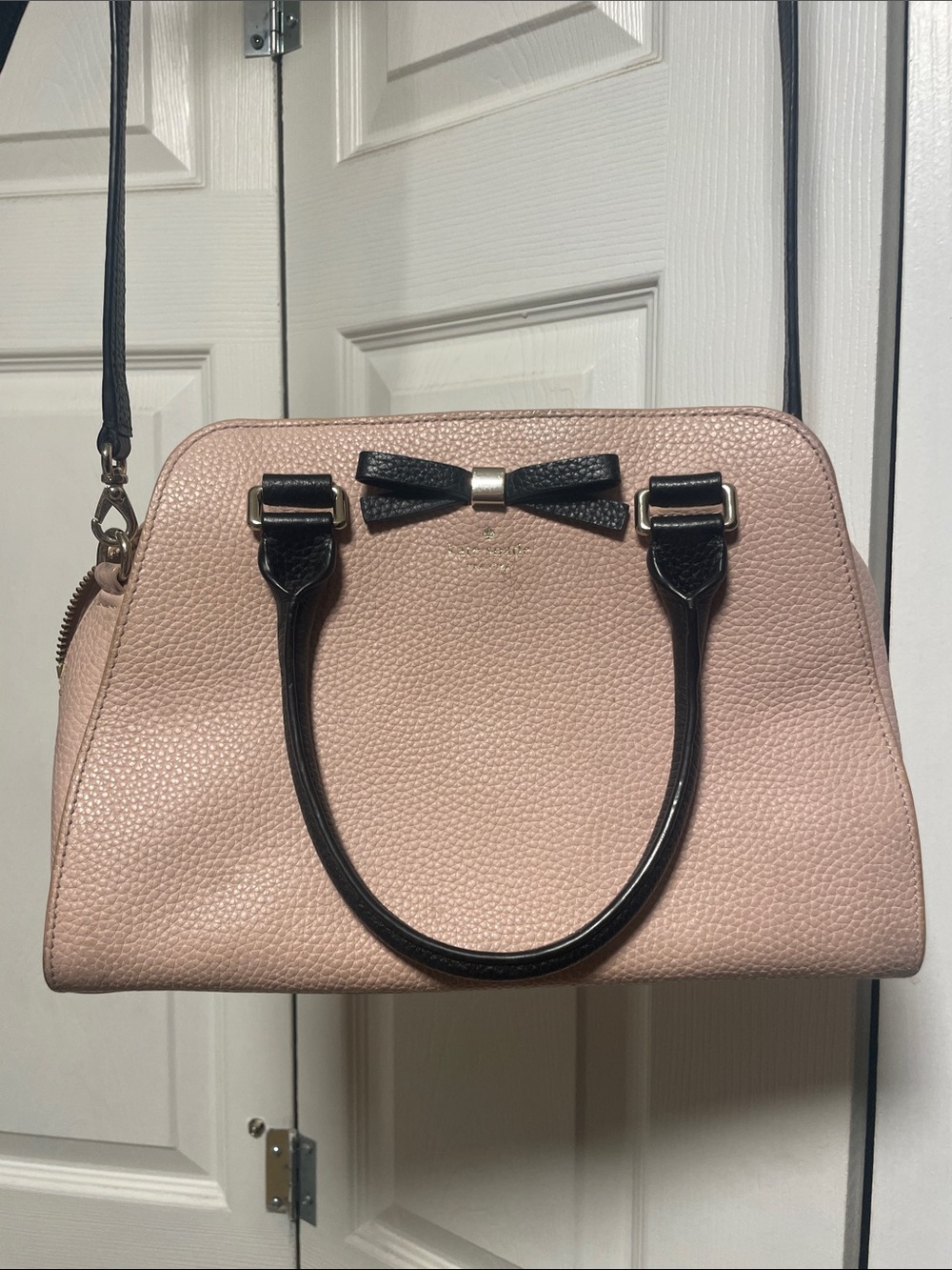 kate spade blush pink satchel with black trim and bow